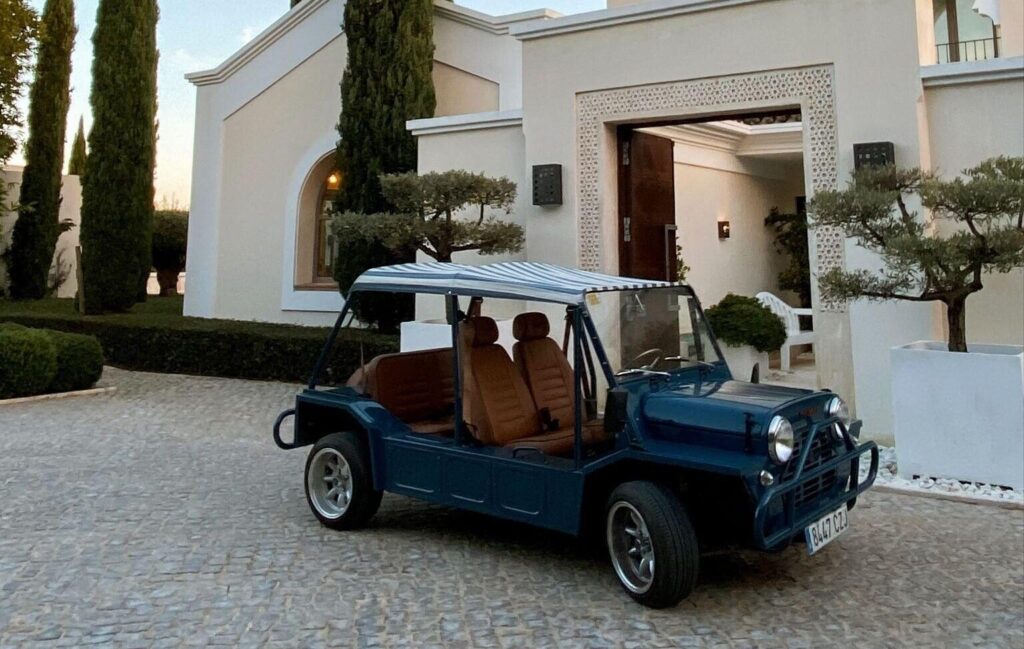 Classic electric Moke parked outside a luxury villa during a Moke experience in Sotogrande