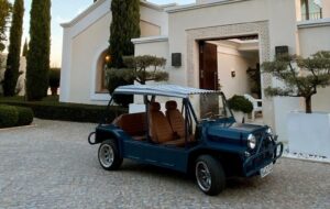 Classic electric Moke parked outside a luxury villa during a Moke experience in Sotogrande