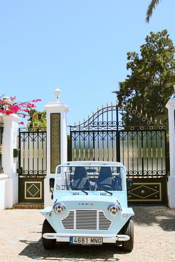 Classic electric Moke parked outside a luxury villa during a Moke experience in Sotogrande